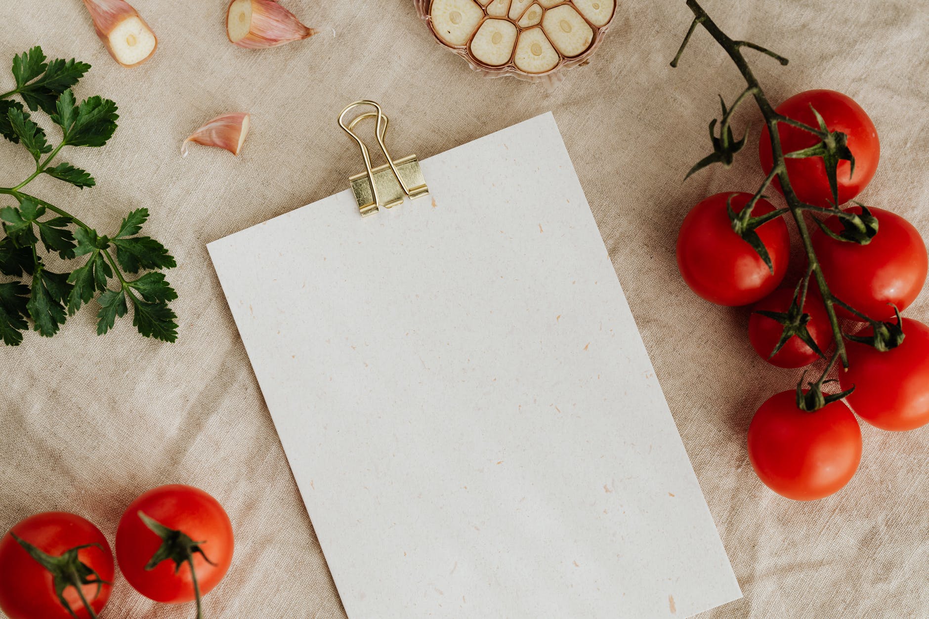 empty clipboard with fresh vegetables and herbs on table